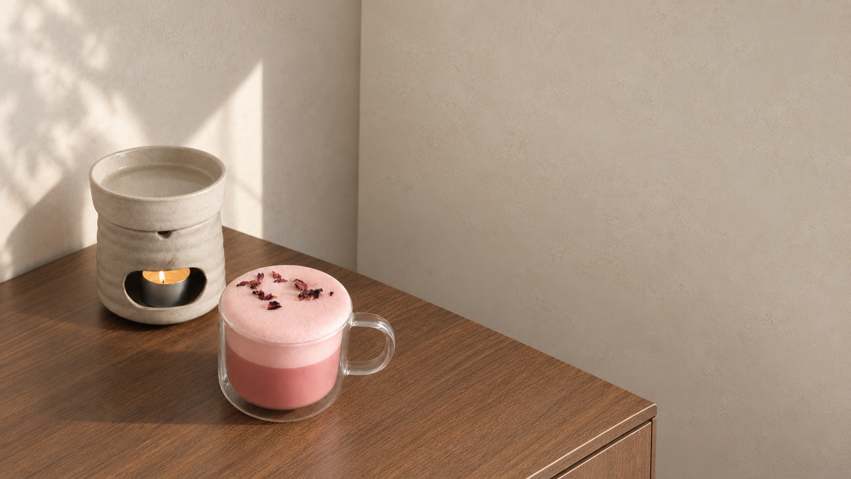 Flow & Bloom signature pink period drink beside a warm ritual burner